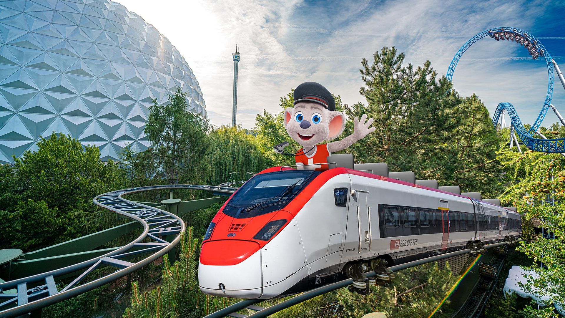 The RailCoaster with the Ed Euromaus figure on the roof runs on a track in Europapark in front of the park's dome and a roller coaster in the background.