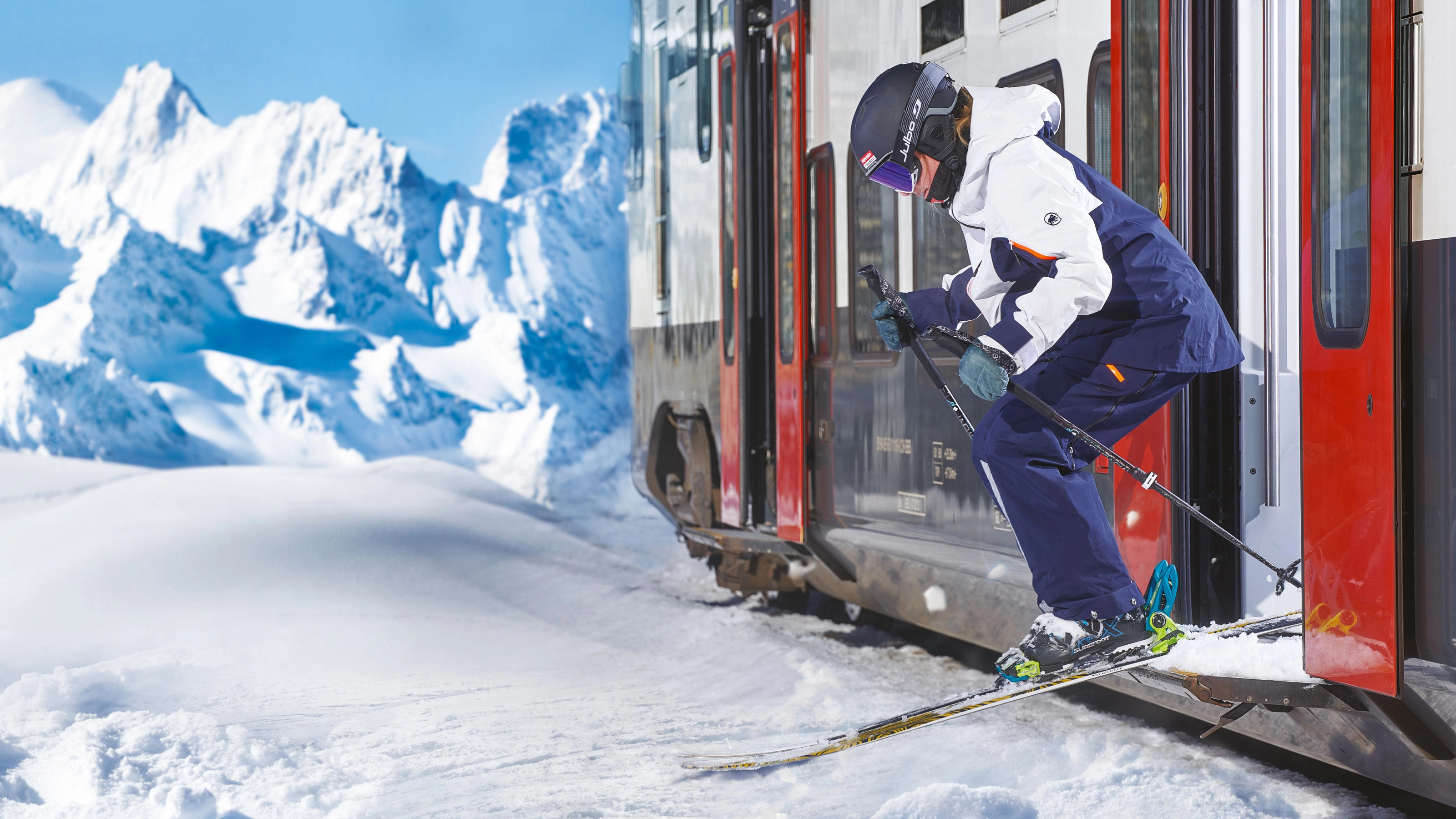 A skier in full ski gear jumps out of a train into a snowy winter landscape.