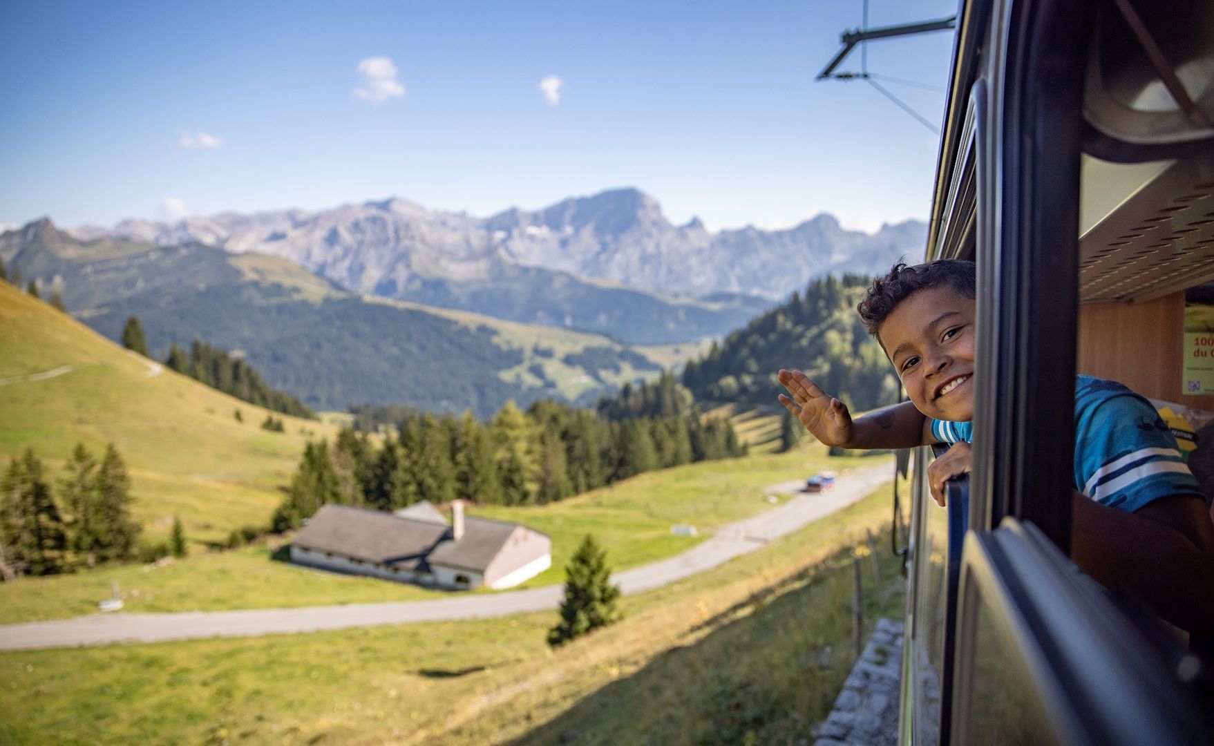Smiling child on the Villars-Bretaye train (BVB line) in summer 