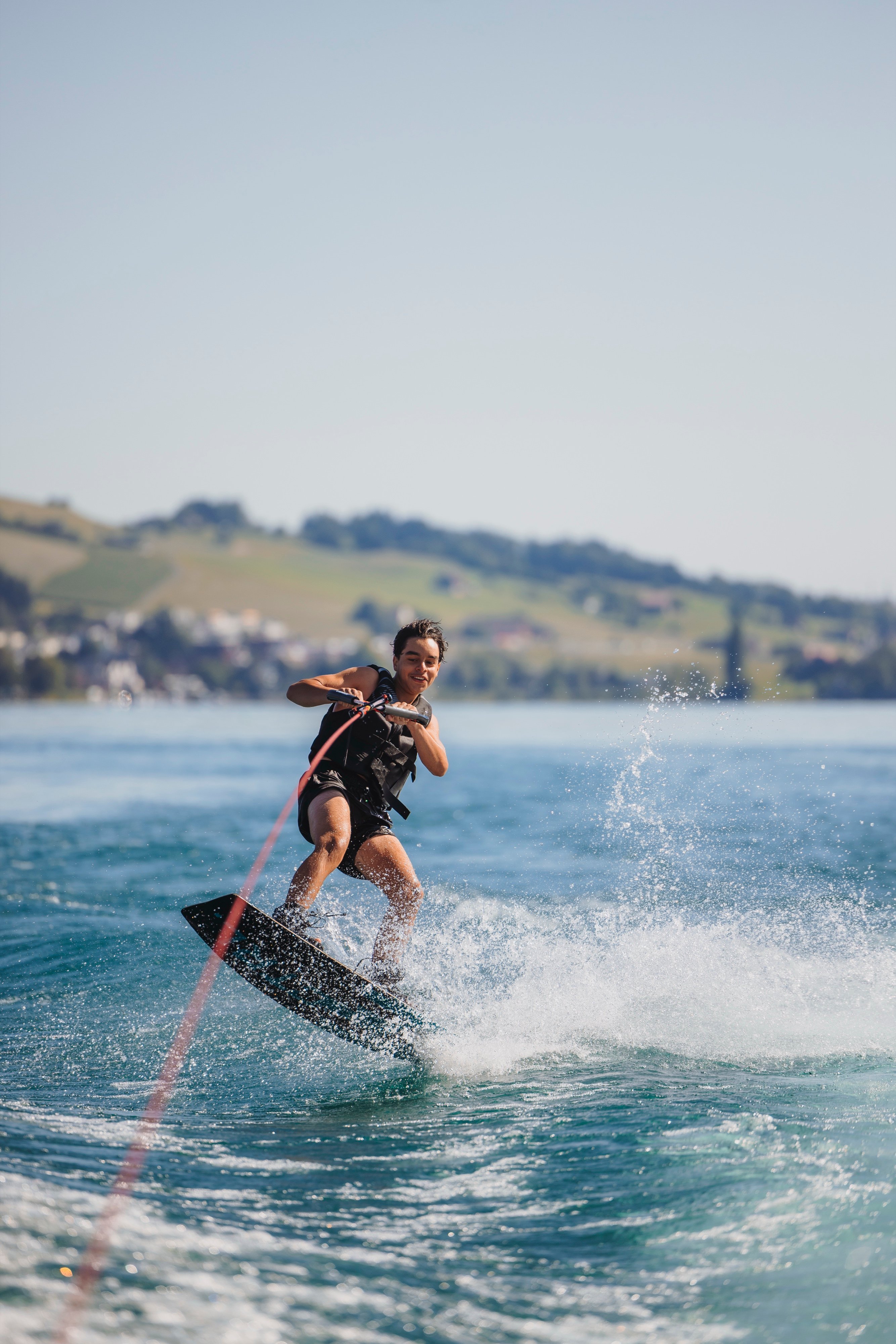 Guest wakeboarding during a private boat tour on Lake Lucerne.