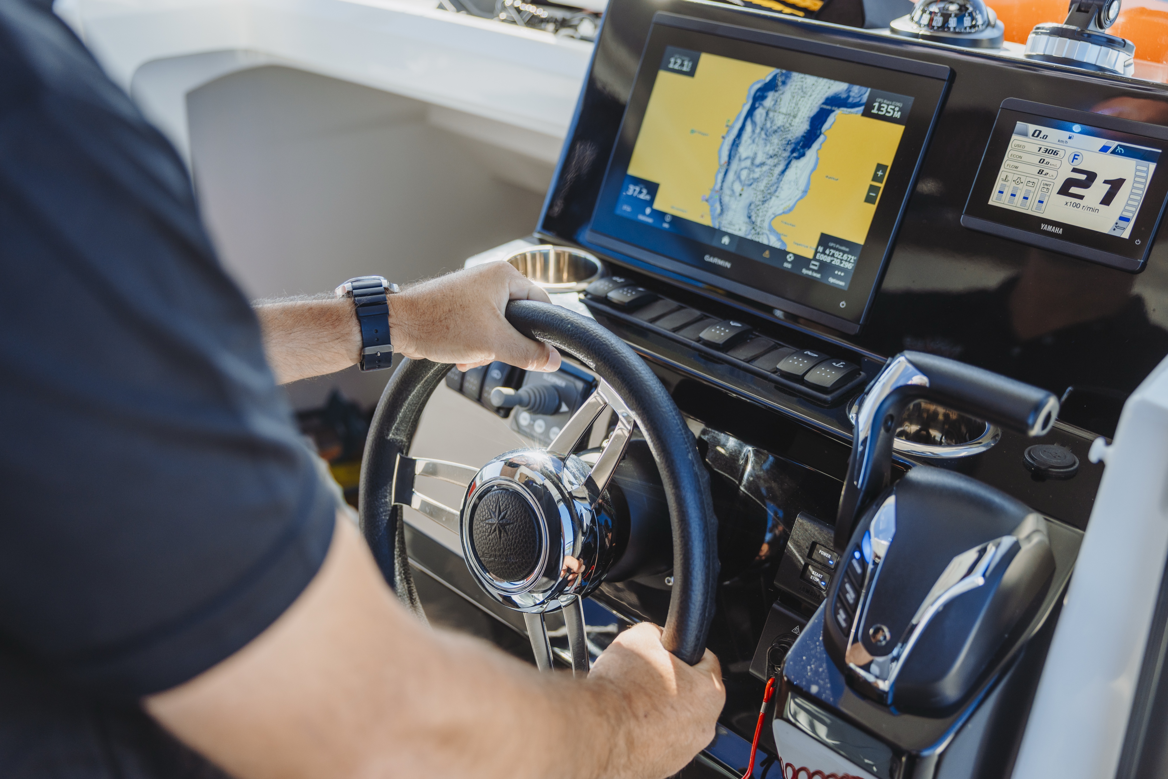 Professional skipper navigating a private boat on Lake Lucerne using modern GPS navigation.