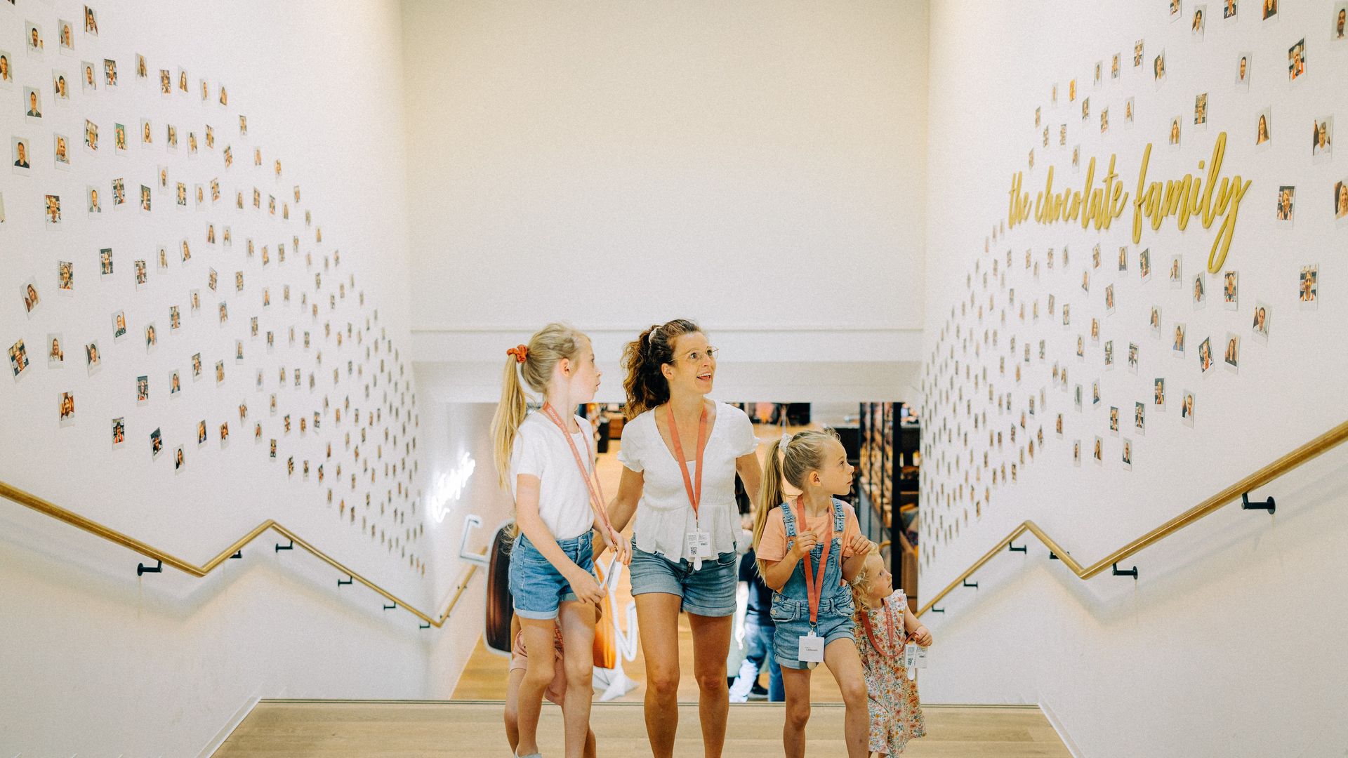 Mother with three children runs up stairs in museum