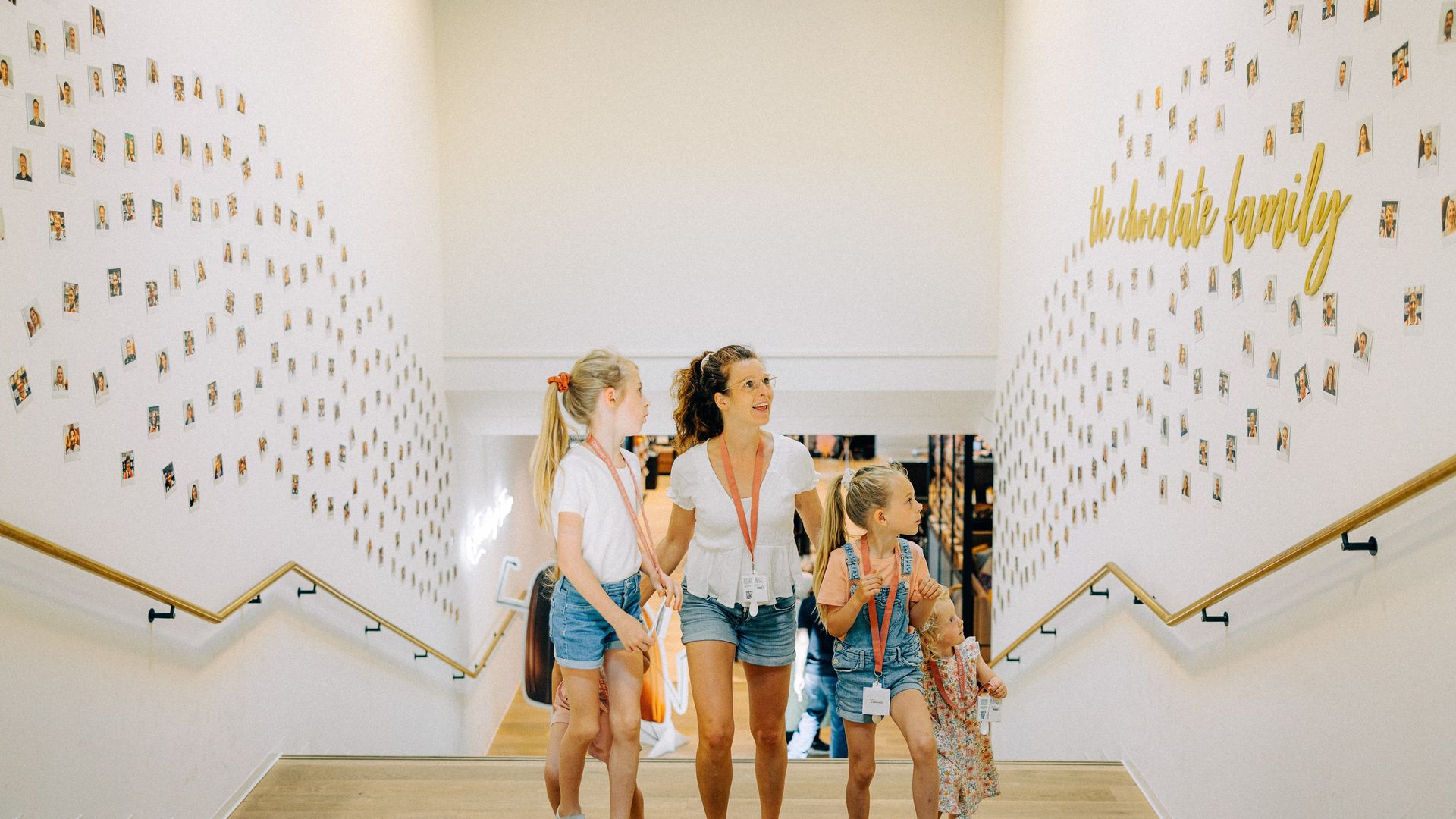 Mutter mit drei Kindern läuft Treppe in Museum hoch