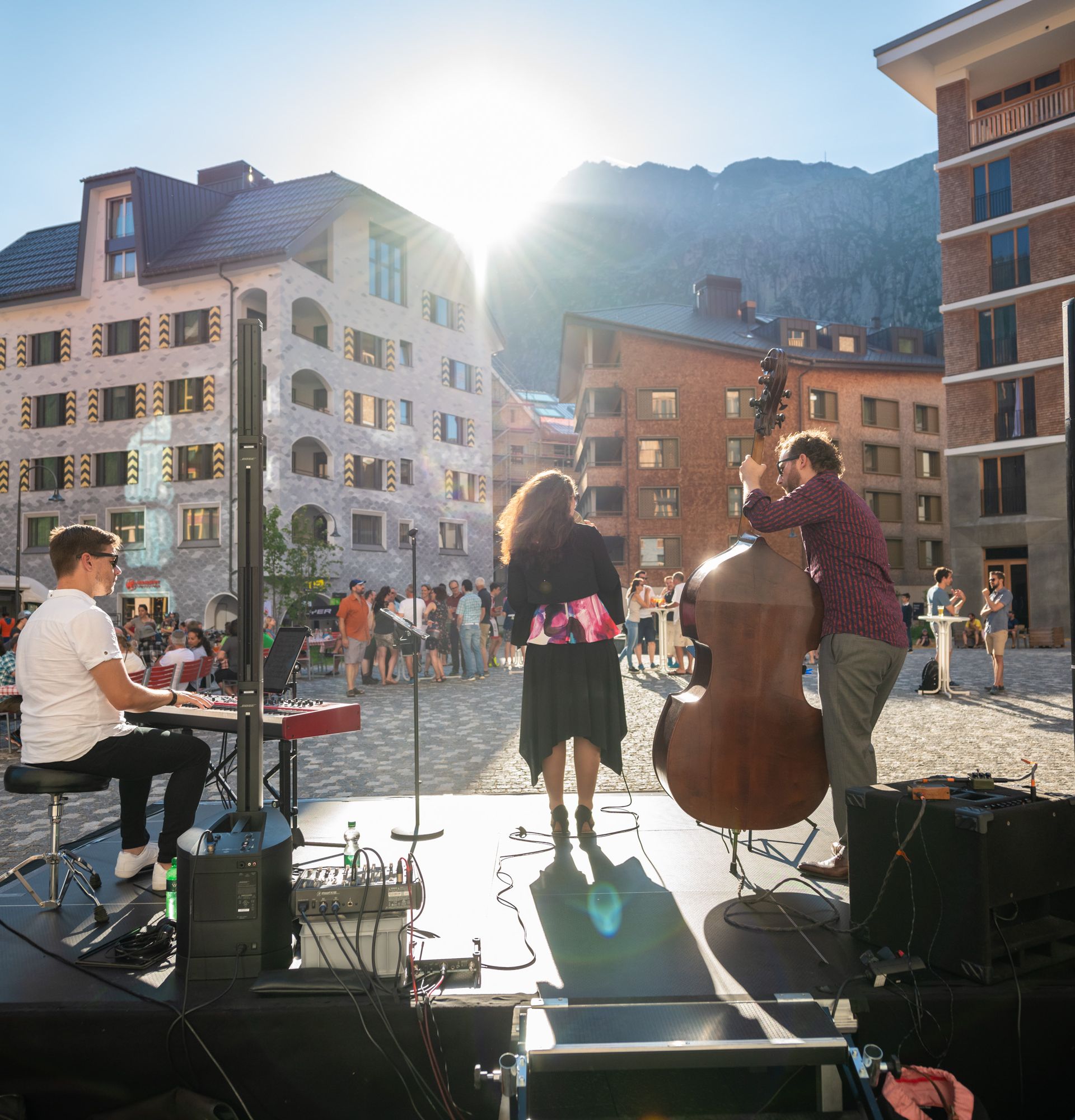 Eine Band mit Sängerin, einem Kontrabass-Spieler und einem Pianisten spielt vor Publikum auf der Piazza Gottardo