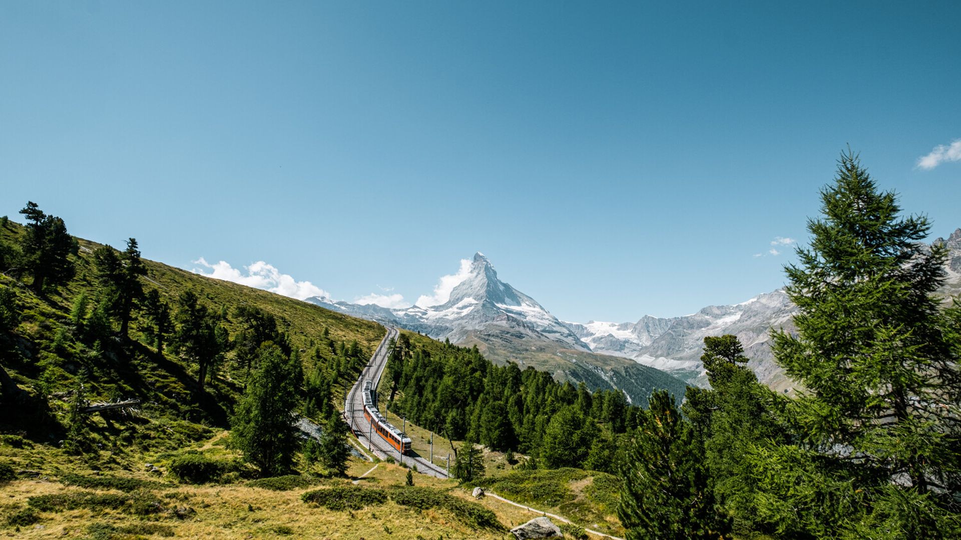 The Gornergrat Bahn in the panoramic curve above Riffelalp with a view of the Matterhorn
