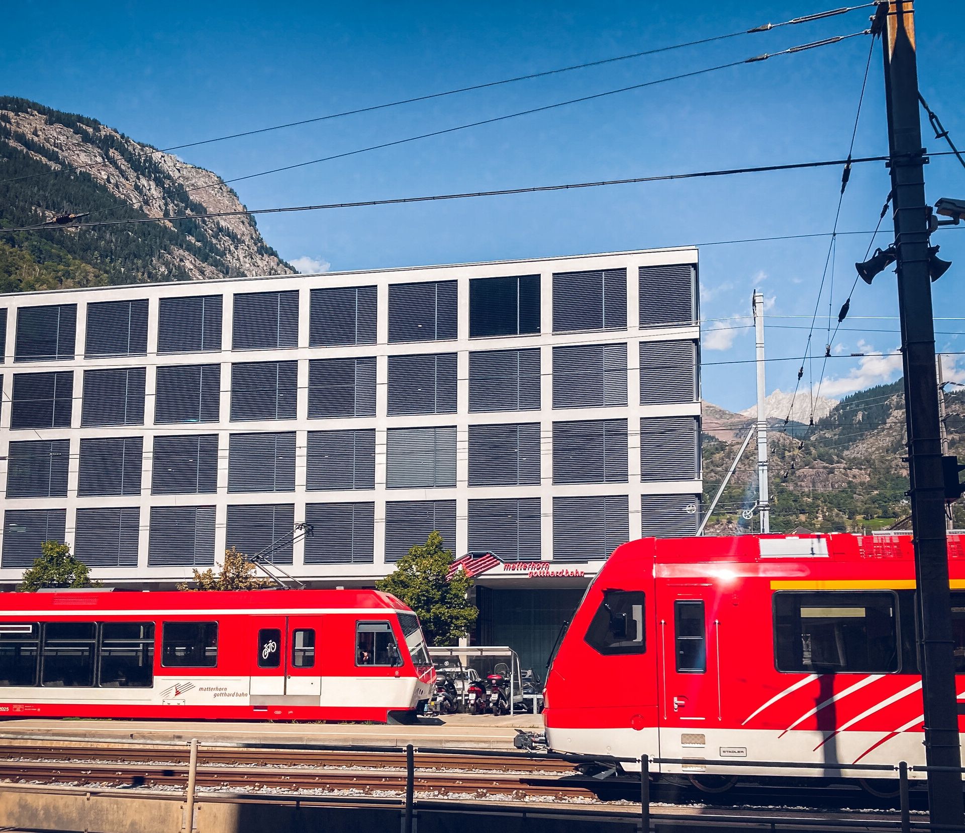 The Matterhorn Gotthard Bahn in Brig, in front of the railway offices, on a sunny day.