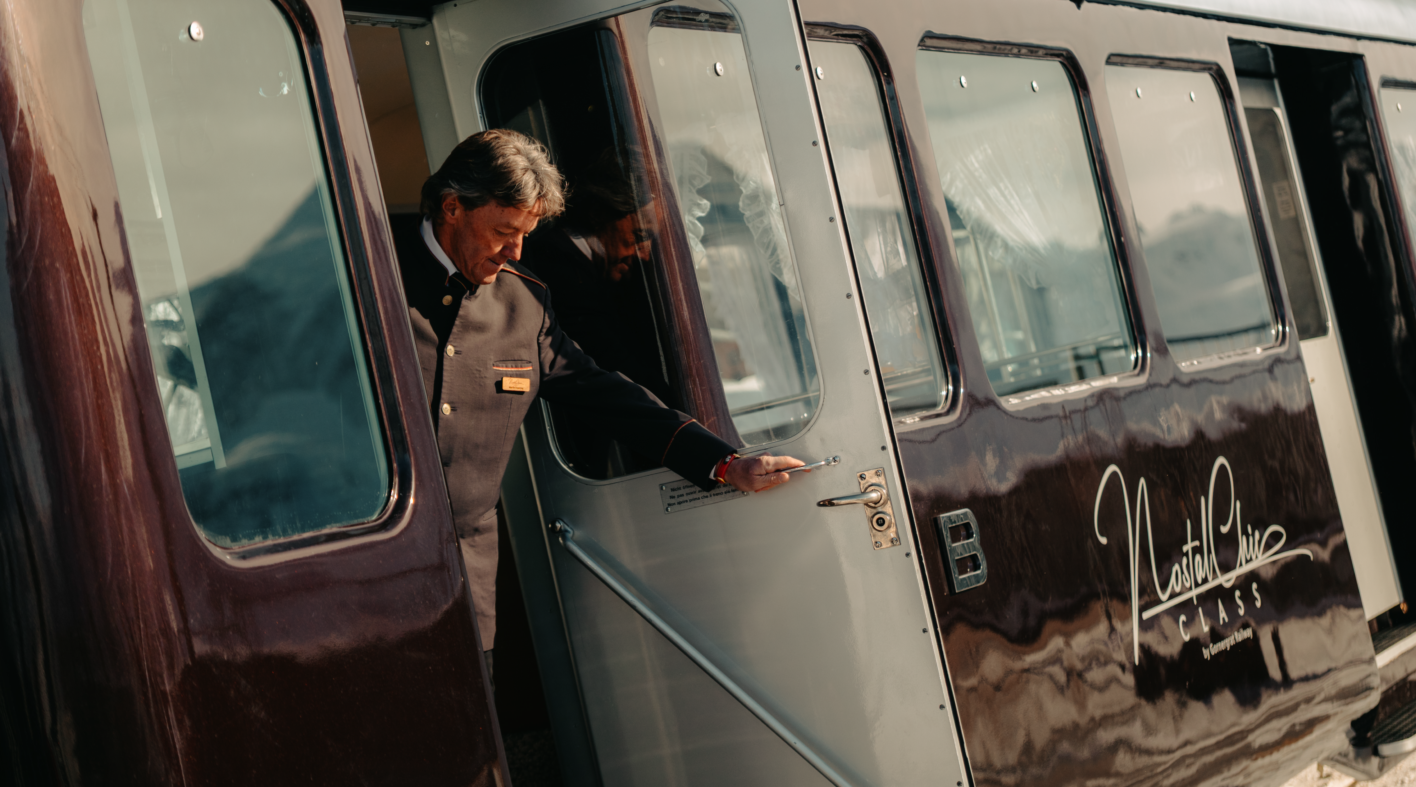 The NostalChic Class carriage travels towards the Matterhorn under partly cloudy skies in the fall season. 