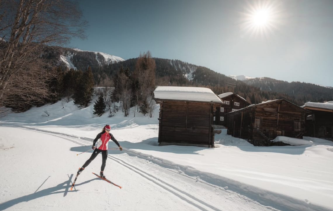 Lady cross-country skiing in Goms