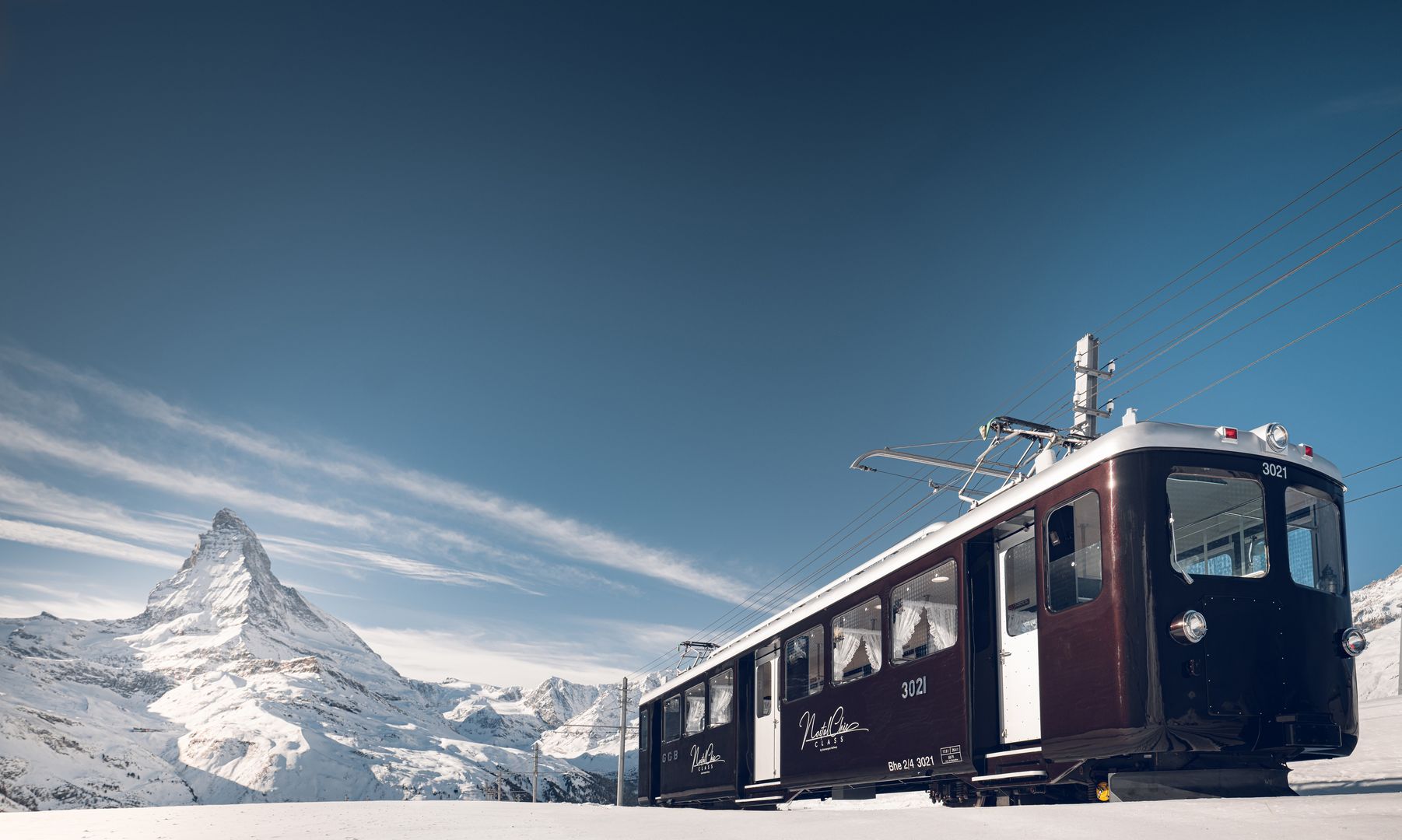 NostalChic Class carriages on the track in winter, view of the Matterhorn