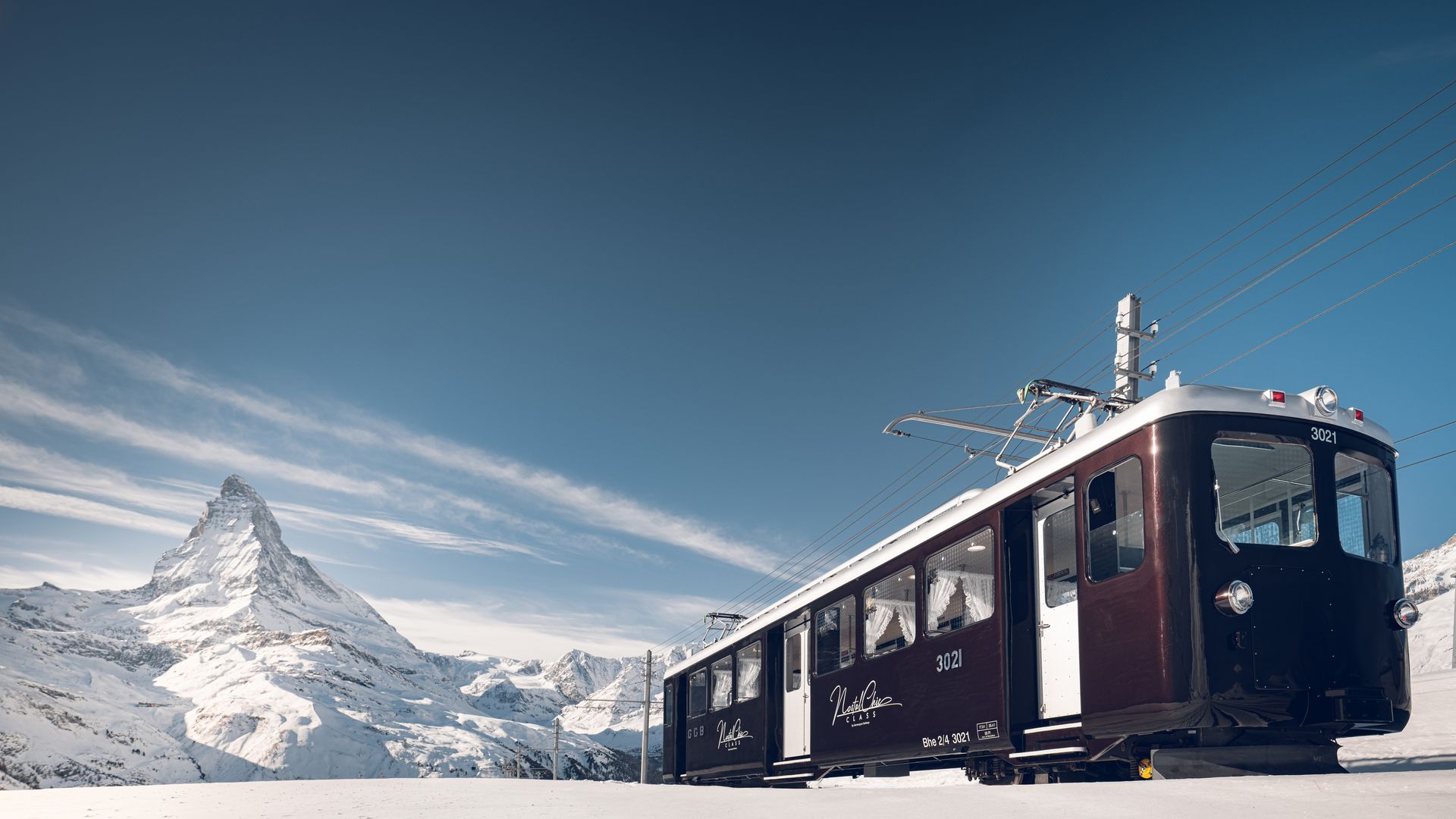 NostalChic Class carriages on the track in winter, view of the Matterhorn
