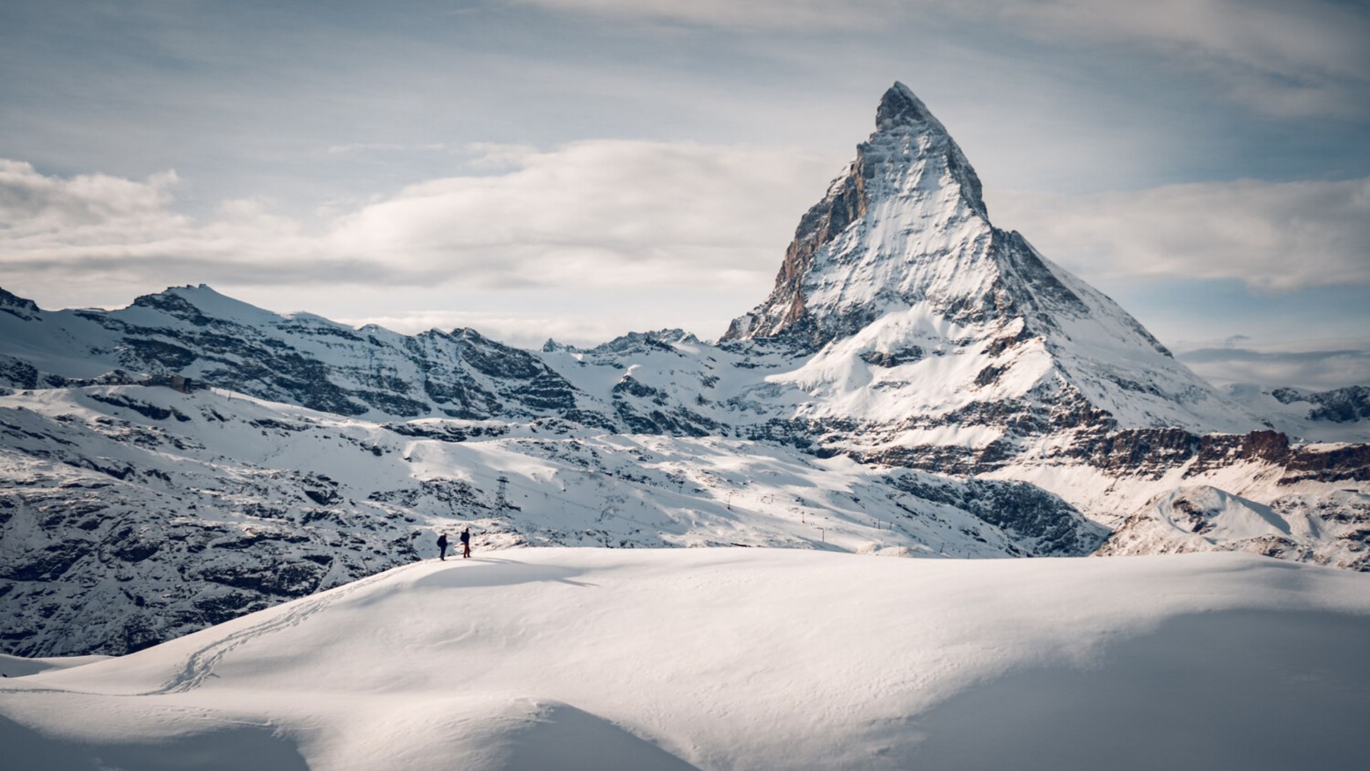 People snowshoing at the Gornergrat above Zermatt with the Matterhorn in the background