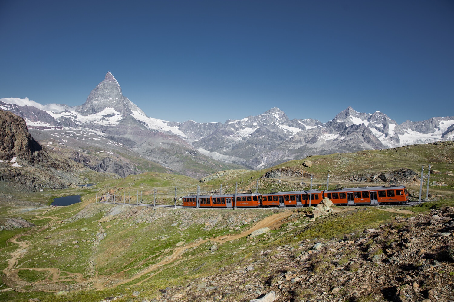 Gornergrat railway at the Rotenboden station with lake Riffelsee in the background