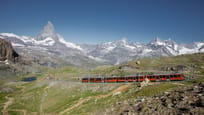 Gornergrat railway at the Rotenboden station with lake Riffelsee in the background