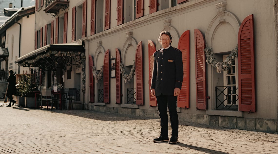 NostalChic Class Concierge Monte Rosa Hotel The NostalChic Class concierge awaits the guests outside the Monte Rosa Hotel, offering a warm welcome.