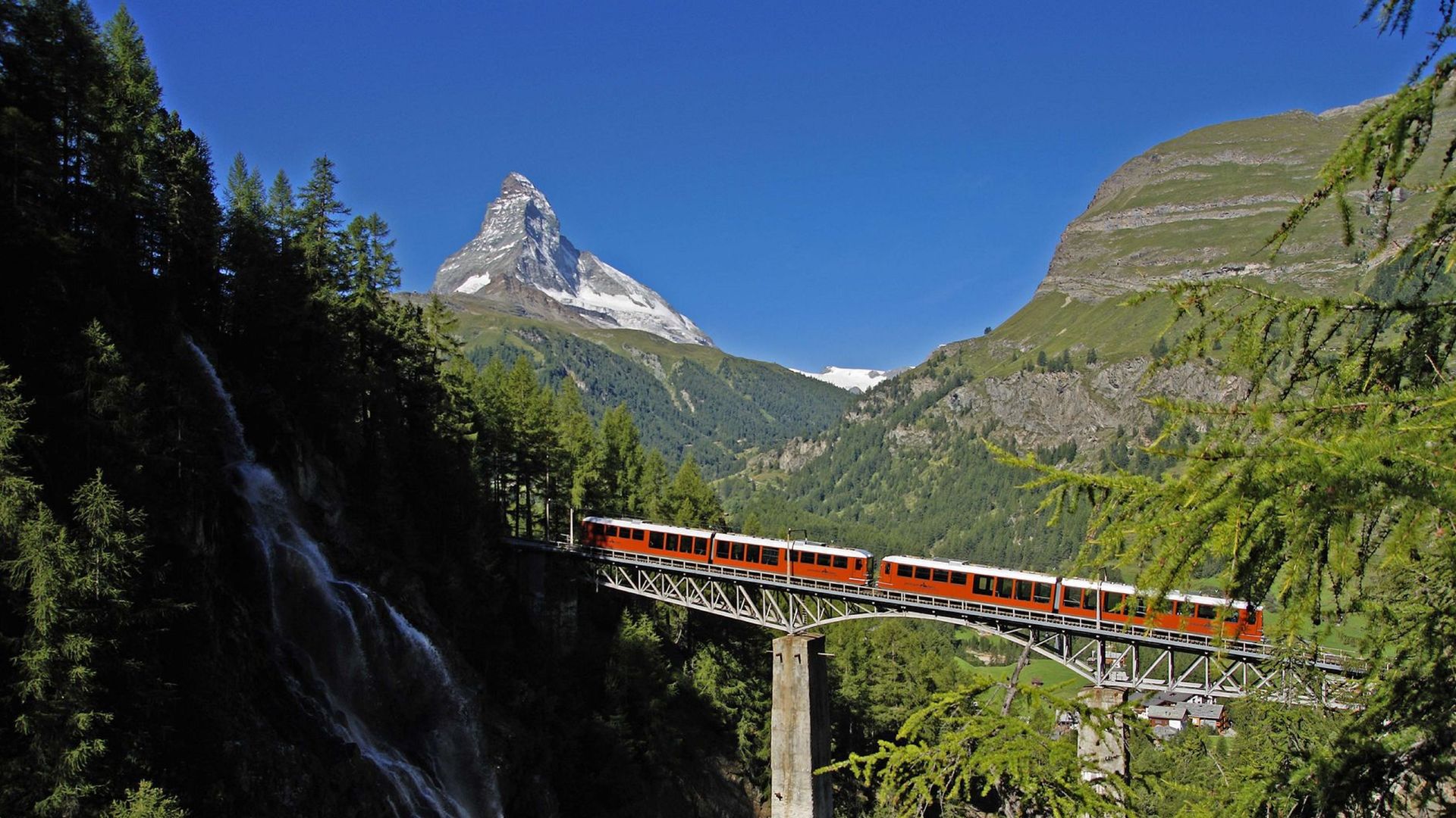 The Gornergrat Bahn crosses the Findelbach Bridge with a view of the Matterhorn in summer