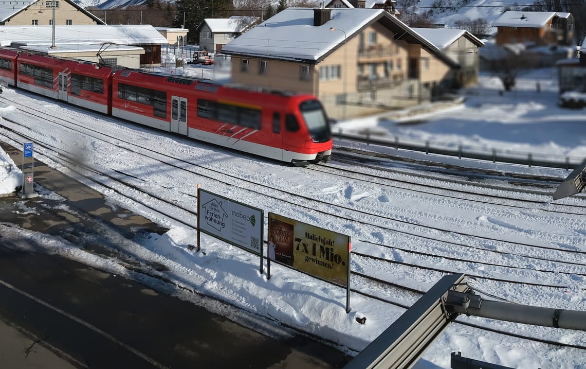 Realp, winter The Realp train passes through a snow-covered town on a sunny day.
