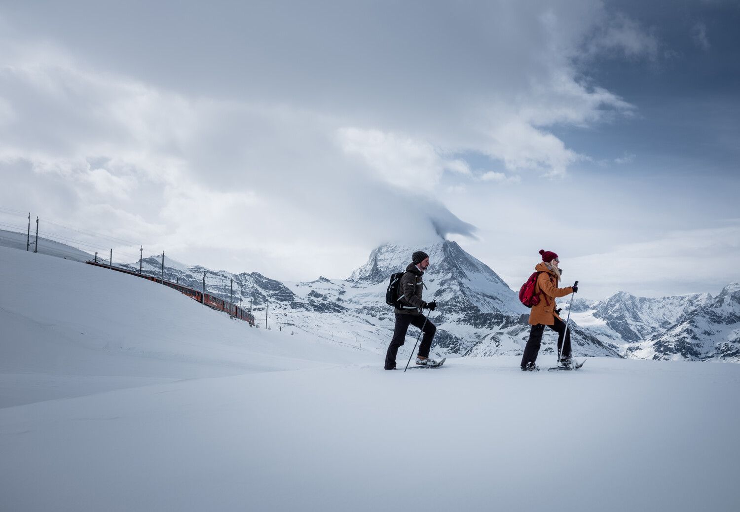 People snowshoeing from Rotenboden to Riffelberg in Winter, Zermatt, Switzerland