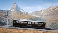 NostalChic Class car on track, view of Matterhorn, summer
